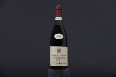 a bottle of wine sitting on top of a black table