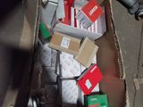 a cardboard box full of assorted items on the ground