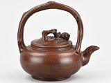 an old teapot with a handle on a white background