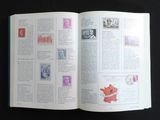 an open book with stamps on it on a table