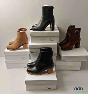 quatre paires de bottines pour femmes sont empilées les unes sur les autres