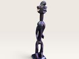 une petite statue d'un homme avec un chapeau sur la tête