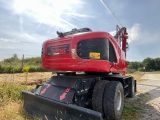 a red tractor that is parked on the side of the road