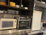 a microwave and a toaster sitting on a counter in a kitchen