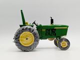 a toy tractor that is sitting on a white surface
