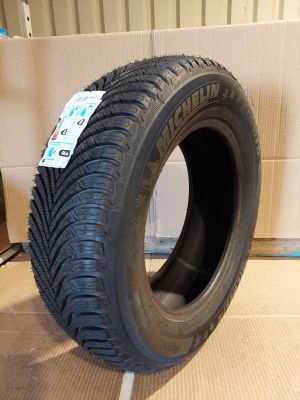 a close up of a tire on a cardboard box in a room