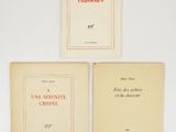 three books are sitting on a white surface next to each other