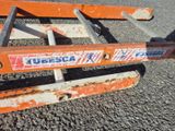 a close up of an orange ladder on the ground