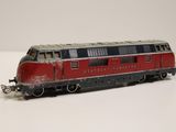 a red and black train car on a white surface