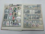an open book with stamps on it on a table