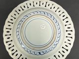 a white plate with a blue design on it