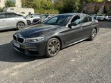 bmw 5 series saloone parked in a parking lot with other cars in the background