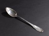 a spoon that is sitting on a black surface
