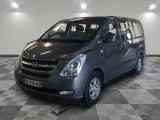 a picture of a grey minivan parked in a garage