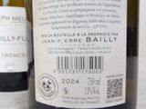 three bottles of wine on a table with a barcode on the label