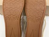 the soles of a pair of shoes that are on a box