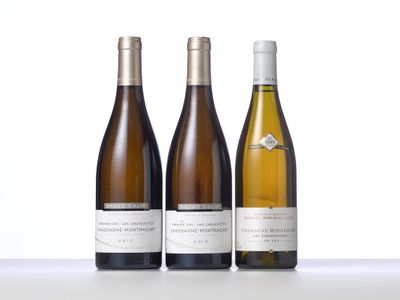 three bottles of wine are lined up on a table