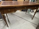 a wooden desk with two drawers on it in a room