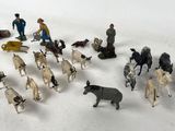 many figurines of people and animals in the snow