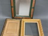 three different colored frames are sitting next to each other on a gray surface