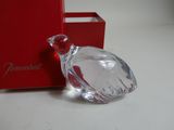 a glass bird that is sitting in front of a red box