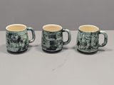 three coffee mugs sitting on top of a table next to each other
