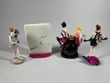 three figurines that are sitting next to each other