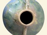 a vase that has a hole in the middle of it