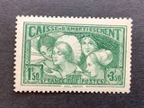 the stamp is green and has a picture of three women on it