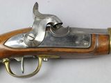 a close up of a gun on a table with a white background