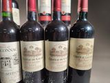 several bottles of wine are lined up on a table