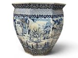 a blue and white vase sitting on a white surface