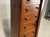 an image of a wooden chest of drawers on a floor