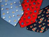three neck ties with different designs on them on a blue surface