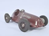 a red toy car with wheels on a white surface