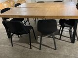 a table and chairs in a room with a large window