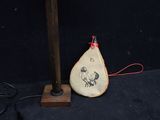a lamp that is sitting on a table next to a bag