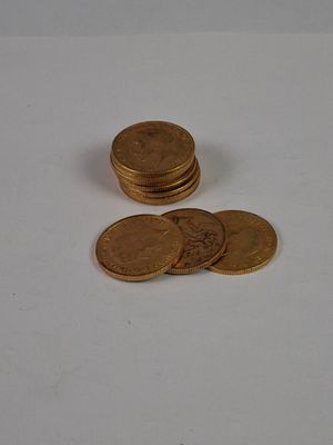 a pile of coins sitting on top of a white table