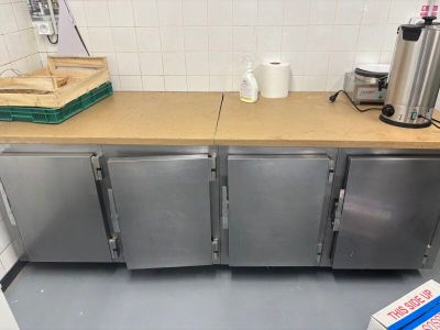 a kitchen with stainless steel cabinets and a counter top