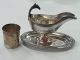 un plateau en argent sur lequel sont posés une tasse et une soucoupe en argent