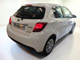 a white toyota yaris parked in a showroom