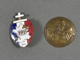 an image of a medal and a coin on a table