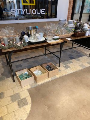 a table with a lot of items on it in front of a store