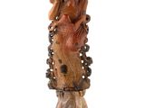 an image of a statue of a woman sitting on top of a tree stump