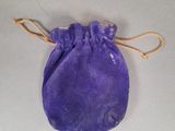 a small purple bag with a string around it on a table