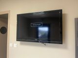 a flat screen tv mounted on a wall in a living room