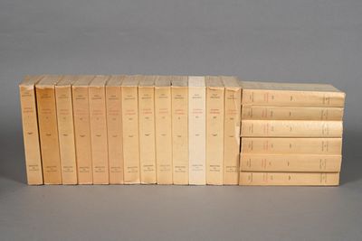 several books stacked on top of each other on a gray surface