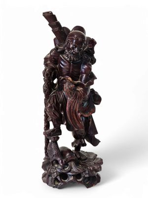 an image of a wooden statue of a man holding a sword
