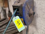a blue machine with a yellow tag attached to it