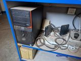 a blue shelf with a computer and other electronics on it